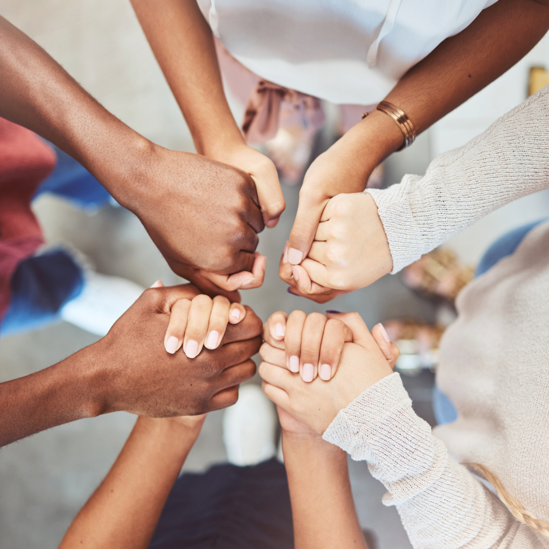 an image of 4 people holding hands in a circle