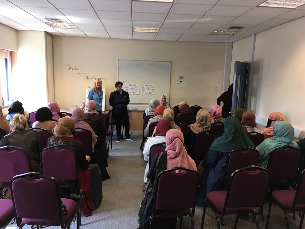 Engagement staff delivering a presentation to a south Asian women's group