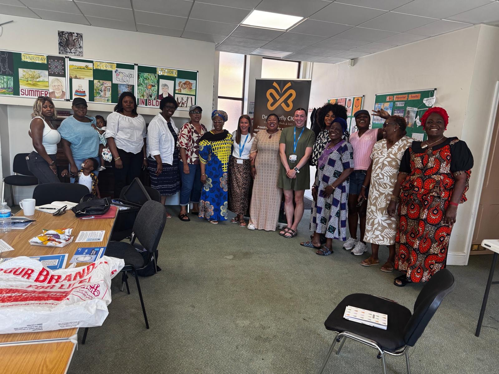 NHS Engagement staff smiling with a community group
