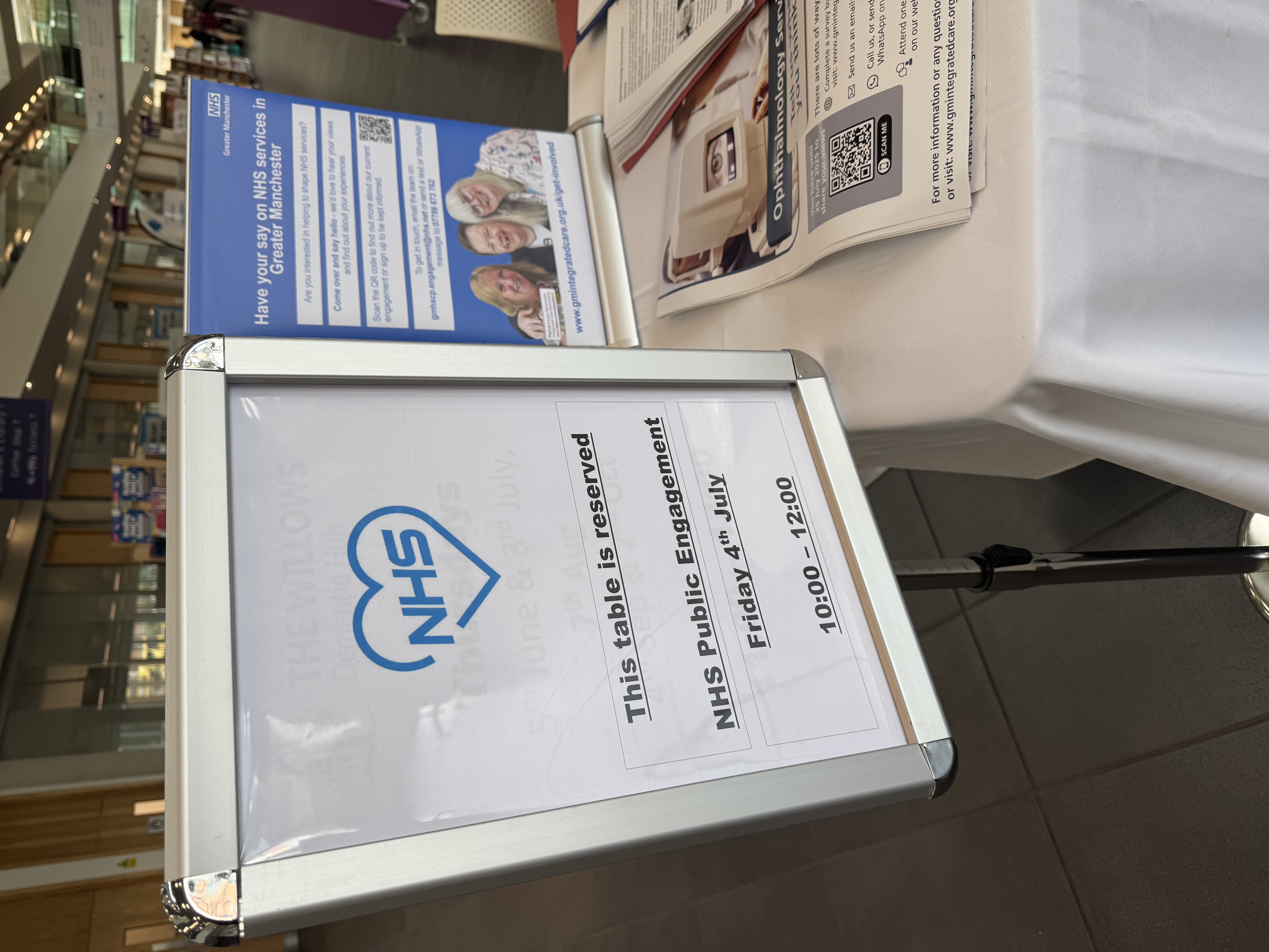 A sign about a NHS pop up engagement stall