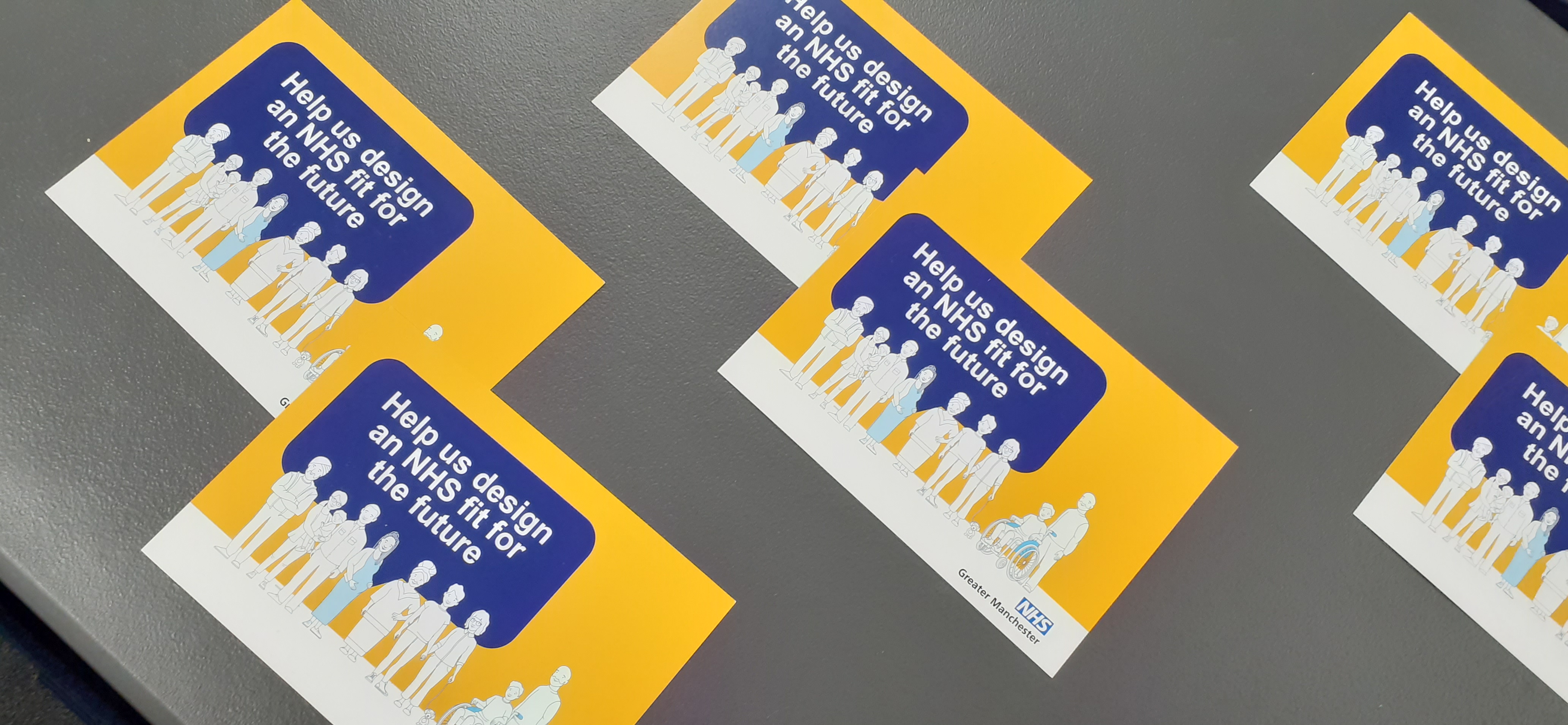 Six postcards with the project headline: Help us design an NHS fit for the future, laid out on a table for decorative purposes