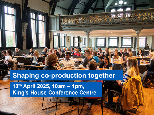 Photo of people in a room looking at the front with the shaping co-production together words