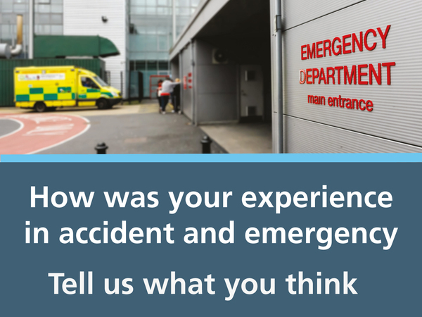 A picture of an emergency department entrance with an ambulance in the background